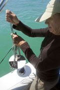 Sarasota County environmental specialist Kathy Meaux preparing to drop a Secchi disk into Sarasota Bay to assess its turbidity.